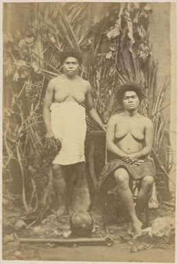 Portrait of Marquee and Eake, with Kanak artefacts, New Caledonia, ca. 1870 / photographed by W. & E. Dufty