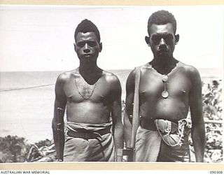 PURIATA RIVER AREA, BOUGAINVILLE. 1945-04-03. CORPORAL PARAURI (1), AND CORPORAL KALAMEN (2), MEMBERS OF A COMPANY, NEW GUINEA INFANTRY BATTALION, ATTACHED 7 INFANTRY BRIGADE, WHO ARE ENGAGED IN ..