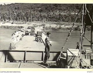 LANGEMAK BAY, NEW GUINEA. 1944-04-23. TROOPS OF THE 5TH DIVISION ABOUT TO BOARD THE AMERICAN SHIP DAVID E. HUGHES (IN THE FOREGROUND), FOR THE JOURNEY TO SAIDOR