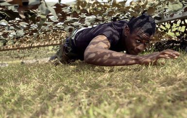 U.S. Air Force 36th Communication Squadron, 36th Air Expeditionary Wing SENIOR AIRMAN Christopher Berry, crawls through an obstacle course during Warrior Day Challenge at Arch Light Memorial Park, Andersen Air Force Base, Guam, on Jan. 14, 2005. (U.S. Air Force PHOTO by STAFF SGT. Bennie J. Davis, III)(RELEASED)