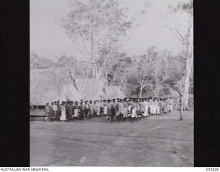 BISIATABU, SOGERI VALLEY, NEW GUINEA. 1943-06-28. EVENING MESS PARADE OF THE 1ST PAPUAN INFANTRY BATTALION. IN CHARGE OF THE PARADE IS NX69905 SERGEANT D. B. EVANS