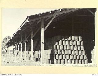 LAE, NEW GUINEA. 1944-03-29. CORRECTLY STACKED AMMUNITION IN ONE OF THE STOREHOUSE AT THE 103RD FIELD AMMUNITION DEPOT. THIS STOREHOUSE WILL BE REPLACED BY A PERMANENT STRUCTURE OF SAWN TIMBER WITH ..