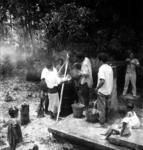 Straining the arrowroot at village pump. (Siale Lahi, Siale Si'i, 'Unaloto (pouring), Saia Foki, Samiu (pumping).)