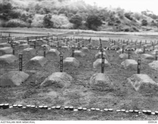 RABAUL, NEW BRITAIN 1946-03-16. OF THE 653 CHINESE WHO DIED WHILST CAPTIVES OF THE JAPANESE 259 WERE RE-INTERRED IN A CHINESE CEMETERY AT RABAUL. THE NEAT GROUNDS, ROWS OF MARKED GRAVES AND AN ..