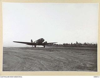 RABAUL, NEW BRITAIN. 1945-10-30. THE FIRST RAAF COURIER PLANE, A DOUGLAS C47 DAKOTA, LANDING ON THE NEWLY RECONDITIONED LAKUNAI AIRSTRIP