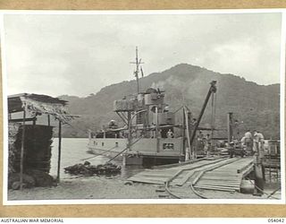 KWIARA, CHINA STRAITS, 1943-07-03. LOOKING ALONG THE JETTY AT THE AB-20, OF THE 1ST AUSTRALIAN WATER TRANSPORT GROUP (SMALL CRAFT)