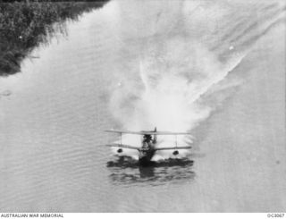 WEWAK AREA, NORTH EAST NEW GUINEA. C. 1945-06. THE SUPERMARINE WALRUS AMPHIBIAN AIRCRAFT OF A RAAF AIR-SEA RESCUE FLIGHT LANDS ON THE SWIFT-RUNNING WATERS OF THE KERAWARI RIVER TO BRING TWO NATIVE ..