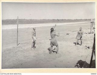 BORAM, NEW GUINEA. 1945-11-21. MEMBERS OF 30 INFANTRY BATTALION, PLAYING DECK TENNIS ON THE BEACH