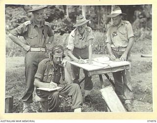 MILILAT, NEW GUINEA. 1944-07-26. PERSONNEL OF "F" TROOP, 64TH BATTERY, 2/14TH FIELD REGIMENT, WORKING OUT THEIR CALCULATIONS AT THE UNIT COMMAND POST DURING A PRACTICE SHOOT. IDENTIFIED PERSONNEL ..