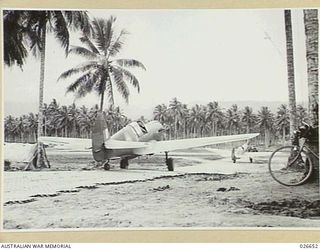 MILNE BAY, PAPUA. 1942-09. KITTYHAWKS OF A RAAF FIGHTER SQUADRON GOING OUT ON A FLIGHT OVER MILNE BAY. THIS PHOTOGRAPH SHOWS COCONUT PALMS AND HOW DISPERSAL RUNWAYS ARE CARVED OUT OF THE THICK ..