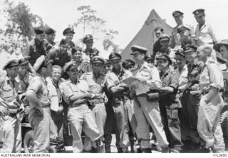 TADJI, NORTH EAST NEW GUINEA. C. 1945-06. INFORMAL GROUP PORTRAIT OF SOME OF THE RAAF BEAUFORT BOMBER AIRCRAFT CREWS WHO PAVED THE WAY FOR THE AIF CAPTURE OF WEWAK DISCUSSING THE RESULTS OF ONE OF ..