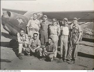 HOLLANDIA, DUTCH NEW GUINEA. C. 1944-06. GROUP PORTRAIT OF AMERICAN AIRCREW AND GROUNDSTAFF MEMBERS OF A US ARMY AIR FORCE UNIT OPERATING LIGHT AIRCRAFT IN A LIAISON AND CASUALTY EVACUATION ROLE. ..