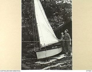 Q101151 PRIVATE L. WARE (1) AND SX39605 LIEUTENANT R. BUTLER, OFFICER- IN- CHARGE (2) WITH AN ALMOST COMPLETED SMALL SAILING BOAT WHICH PERSONNEL OF NO. 5 PLATOON (PIONEERS), HEADQUARTERS COMPANY, ..