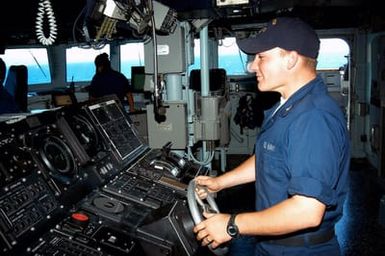 U.S. Navy Boatswains Mate 3rd Class Justin Bevitt navigates the Arleigh Burke Class Guided Missile Destroyer USS CHUNG-HOON (DDG 93) during aa Communications and Passing Exercise with Chinese Navy ships in the Pacific Ocean on Sept. 10, 2006. (U.S. Navy photo by Mass Communication SPECIALIST 3rd Class Ben A. Gonzales) (Released)