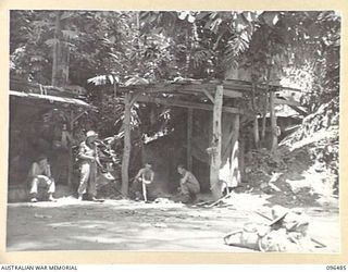 RABAUL, NEW BRITAIN, 1945-09-12. MEMBERS OF A COMPANY 29/46 INFANTRY BATTALION, CAMPED NEAR THE ENTRANCE TO A JAPANESE TUNNEL SYSTEM DURING THE EARLY STAGES OF THE OCCUPATION OF RABAUL BY A FORCE ..
