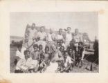 Soldiers pose with local boys on Fiji, 1940s