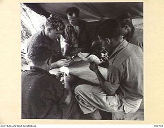 KARAWOP, NEW GUINEA, 1945-09-18. MEMBERS OF 2/6 CAVALRY COMMANDO REGIMENT PLAYING THE CARD GAME 500. FOLLOWING THE JAPANESE SURRENDER MOST OF THEIR SPARE TIME IS SPENT SWIMMING OR PLAYING CARDS