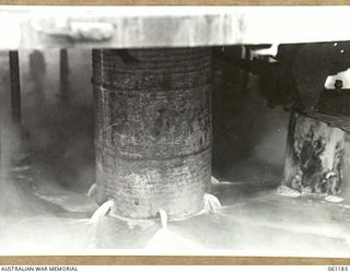 17 MILE, PORT MORESBY AREA, NEW GUINEA. 1943-12-04. DIRTY WATER BEING RUN AWAY FROM THE WASHING MACHINES AT THE 9TH AUSTRALIAN DIVISION MOBILE LAUNDRY