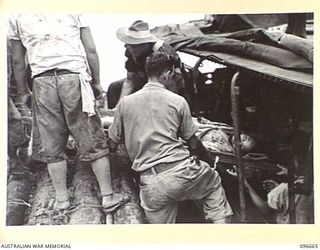 BONIS PENINSULA, BOUGAINVILLE. 1945-09-16. MEDICAL PERSONNEL OF 17 FIELD AMBULANCE SUPERVISING THE LOADING OF SERIOUSLY ILL JAPANESE TROOPS ON TO AN AMBULANCE BARGE FOR MOVEMENT TO 17 FIELD ..