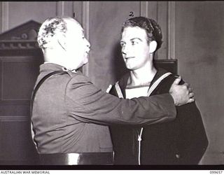 LAE, NEW GUINEA, 1945-12-18. LIEUTENANT J. P. STORR, (DUKE OF AYR AND STIRLING) (1) AND SERGEANT A. WHITE, (EARL OF HARPENDON) (2) PLAYERS OF DETACHMENT 12 ENTERTAINMENT UNIT, IN A SCENE FROM THE ..