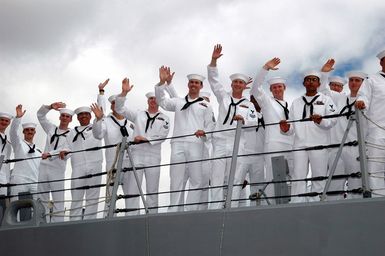 U.S. Navy Sailors manning the rails of their ship, the Arleigh Burke Class Guided Missile Destroyer USS RUSSELL (DDG 59), wave as they return home at Naval Station Pearl Harbor, Hawaii, on Sept. 5, 2006, following a six-month deployment. RUSSELL departed this year as part of the Abraham Lincoln Carrier Strike Group and later joined the Kitty Hawk CSG before returning here at Pearl Harbor. (U.S. Navy photo by Mass Communication SPECIALIST 1ST Class James E. Foehl) (Released)