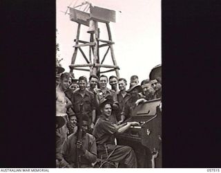 KAIAPIT, NEW GUINEA. 1943-09-23. MEN OF THE 2/6TH AUSTRALIAN CAVALRY (COMMANDO) SQUADRON PATCHED UP THE BELLOWS OF THIS BULLET RIDDLED ORGAN FROM THE KAIAPIT LUTHERAN MISSION AND HAD A SING SONG ON ..