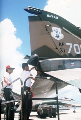 Ground crewman pack a drogue chute into the tail of a Hawaii Air National guard F-4C Phantom II aircraft