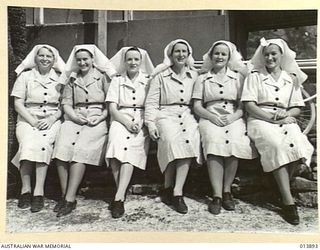 1942-12-18. NEW GUINEA. THESE NURSES, THE FIRST RAAF NURSES TO ARRIVE IN NEW GUINEA WERE CHEERED ON THEIR ARRIVAL. LEFT TO RIGHT - SISTERS E.M. WEBER (ROCKHAMPTON, QLD), N. GARDNER (PORT MACQUARIE ..