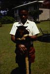 Boy holding a tree-climbing kangaroo, Goroka, [Papua New Guinea], 1969