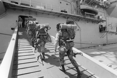 Marines board the amphibious assault ship USS GUAM (LPH 9) during the field training Exercise SOLID SHIELD'87
