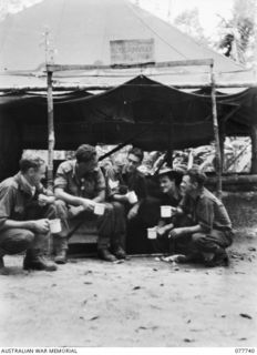 TORINKA, BOUGAINVILLE ISLAND. 1944-12-28. PERSONNEL OF THE 15TH INFANTRY BRIGADE SIGNALS SECTION HAVING A CUP OF TEA AFTER THEIR ARRIVAL ON THE ISLAND ON THE MV "DUNTROON". IDENTIFIED PERSONNEL ..