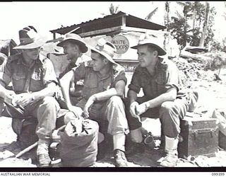 WEWAK HARBOUR, NEW GUINEA, 1945-12-13. APPROXIMATELY 2,200 MEMBERS OF 6 DIVISION EMBARKED ON THE AIRCRAFT CARRIER HMS IMPLACABLE FOR RETURN TO AUSTRALIA. SHOWN, MAJOR B. J. FRENCH (1); LIEUTENANT ..