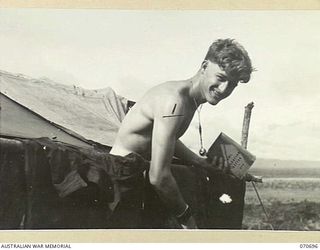 RAMU VALLEY, NEW GUINEA, 1944-02-29. N335254 PRIVATE J.M. RUSSELL, A MEMBER OF THE MORTAR PLATOON, 2/12TH INFANTRY BATTALION, CARRYING OUT SCRUB TYPHUS PRECAUTIONS