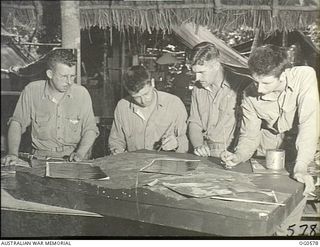 MILNE BAY, PAPUA. 1943-07-31. THE COMPOSITE PICTURES OF A MOSAIC BEING USED TO MAKE A TOPOGRAPHIC MODEL. PRINTS WHICH MAKE UP THE MOSAIC CAME FROM FILM EXPOSED DURING AN OPERATIONAL MISSION BY A ..