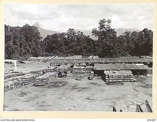 LAE AREA, NEW GUINEA. 1945-07-12. THE DRUM FILLING AREA OF 2 BULK PETROLEUM STORAGE COMPANY, VIEWED FROM THE TOP OF NO. 2 BULK STORAGE TANK. THIS COMPANY IS RESPONSIBLE FOR THE STORING AND ..