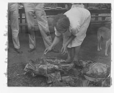 [Native Woman Opens a Leaf Bundle]
