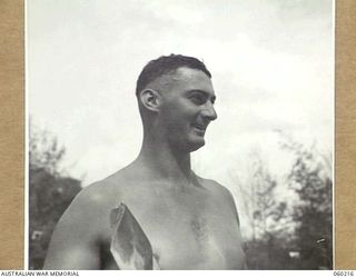 ELA BEACH, NEW GUINEA. 1943-11-13. GUNNER A. HUNT OF THE 2ND AUSTRALIAN FIELD REGIMENT WINNER OF THE 12 INCH UNDERHAND WOODCUT AT THE COMBINED SERVICES SPORTS MEETING