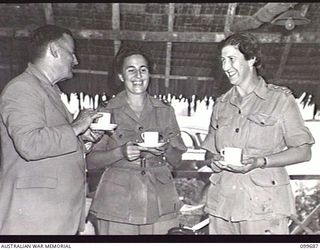 LAE, NEW GUINEA, 1946-01-28. THE HONOURABLE F. M. FORDE, MINISTER FOR THE ARMY, (1), CHATTING WITH SISTER K. T. LORENZ, AUSTRALIAN ARMY NURSING SERVICE (2) AND LIEUTENANT E. L. CRANE, AUSTRALIAN ..