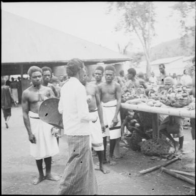 Woman with basket approaching a trestle table, Boong, native market, Rabaul, New Guinea, ca. 1936 / Sarah Chinnery