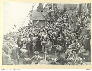 BOUGAINVILLE ISLAND, SOLOMONS. 1944-11-01. TROOPS OF THE 3RD AUSTRALIAN DIVISION HEADQUARTERS AND ATTACHED PERSONNEL LINED UP ON THE DECK OF THE AMERICAN LIBERTY SHIP, LINDLEY M. GARRISON WAITING ..