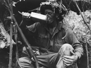 BOUGAINVILLE ISLAND. 1944-12-30. QX61728 PRIVATE V. MULCAHY, ENJOYING A DRINK OF TEA DURING A LULL IN THE FIGHTING IN THE AUSTRALIAN ATTACK ON JAPANESE POSITIONS IN THE PIATERAPAIA SECTOR BY THE ..