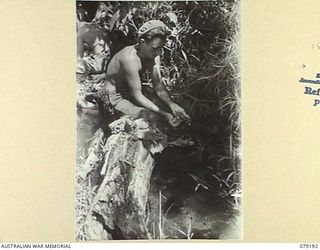 BOUGAINVILLE ISLAND. 1945-02-17. QX1499 PRIVATE E.A. PITT, 9TH INFANTRY BATTALION TAKING ADVANTAGE OF A LULL IN THE FIGHTING TO WASH HIS CLOTHES IN A MOUNTAIN STREAM