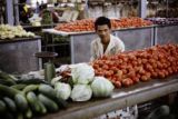 French Polynesia, merchant selling vegetables at market in Papeete