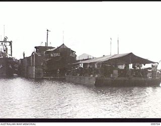 RABAUL, NEW BRITAIN, 1946-01-30. A PREFABRICATED FLOATING DOCK, 400 TONS, WAS ASSEMBLED BY 13 WATER TRANSPORT WORKSHOPS, CORPS OF AUSTRALIAN ELECTRICAL AND MECHANICAL ENGINEERS, AT RABAUL. PARTS ..