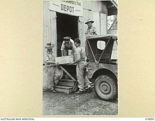 MILILAT, NEW GUINEA. 1944-07-20. COMFORTS FOR THE TROOPS IN THE FORWARD AREAS BEING LOADED INTO A JEEP AT THE AUSTRALIAN COMFORT FUND STORE. IDENTIFIED PERSONNEL ARE:- QX46233 PRIVATE J. LOGAN (1); ..