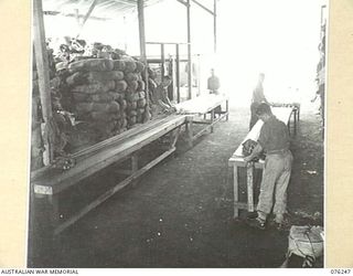 LAE, NEW GUINEA. 1944-09-27. FABRIC WORKERS REPAIRING PARACHUTES IN THE PARACHUTE SECTION OF THE 43RD FIELD ORDNANCE DEPOT