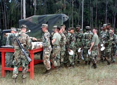 A group of US Marines from 1ST Battalion, 3rd Marines, Weapons Company, wait in line for chow after a day of training at Schofield Army Barracks, Hawaii