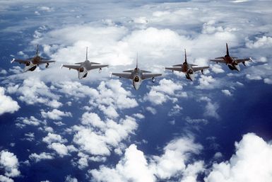 An air-to-air front view of five F-16 Fighting Falcon aircraft, from the 428th Tactical Fighter Squadron, flying in wedge formation while en route to Hawaii to participate in Exercise Cope Elite