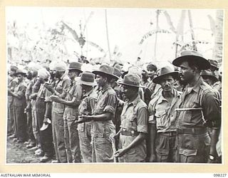 KARAVIA BAY, NEW BRITAIN. 1945-10-23. MAJOR GENERAL K.W. EATHER, GENERAL OFFICER COMMANDING 11 DIVISION, VISITED THE INDIAN EX-PRISONER OF WAR CAMP AT KARAVIA BAY. SHOWN, A SECTION OF THE CROWN ..