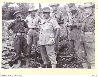 WEWAK AREA, NEW GUINEA, 1945-06-14. GENERAL SIR THOMAS A. BLAMEY, COMMANDER-IN-CHIEF, ALLIED LAND FORCES, SOUTH WEST PACIFIC AREA (3),AND PARTY, INSPECTING A NATIVE GARDEN AT CAPE MOEM. IDENTIFIED ..